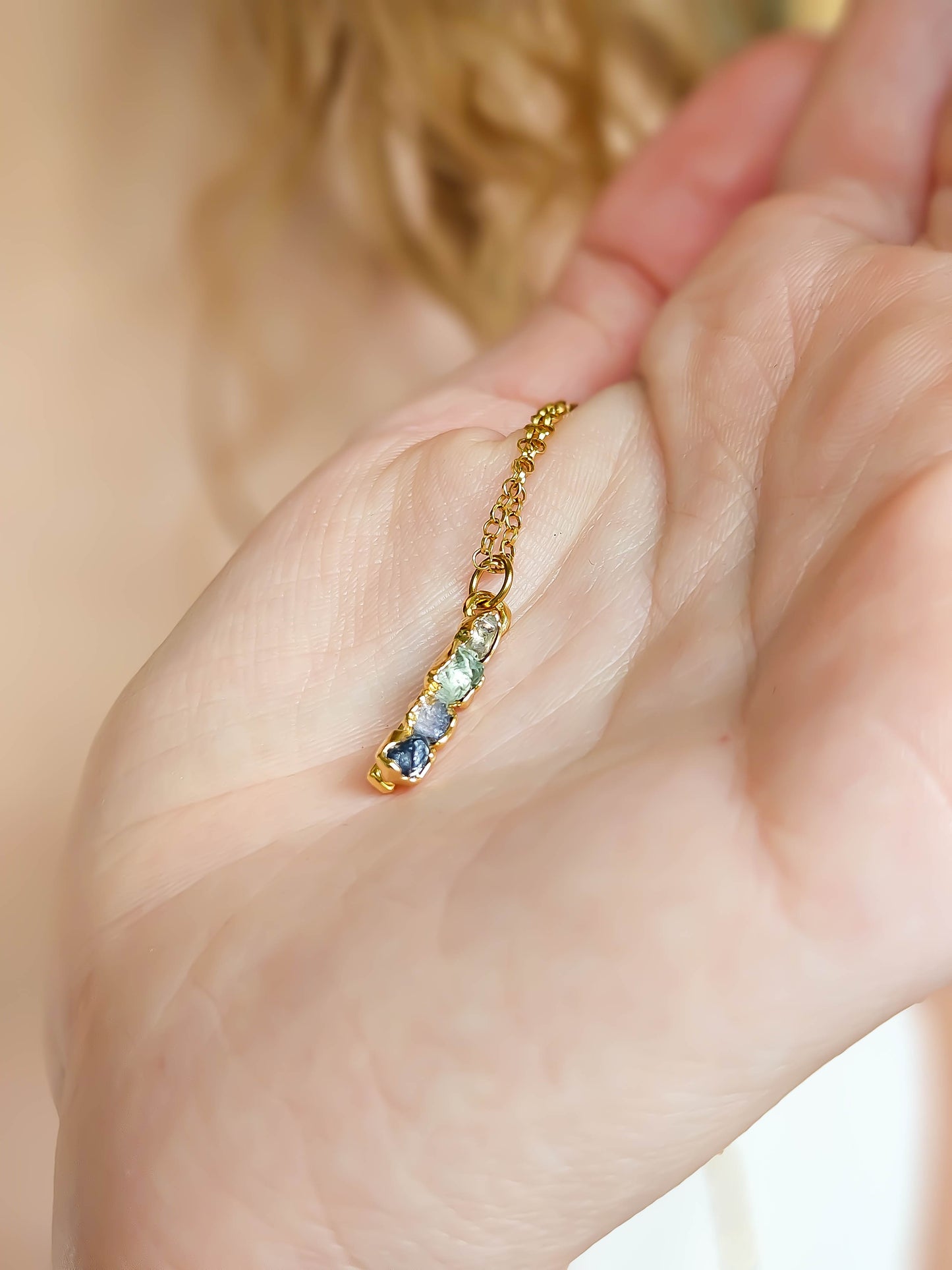 Détail des pierres de naissance naturelles montées sur un pendentif fait main